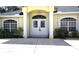 Inviting home entrance featuring a double door, arched window, and columns at 2244 Mauritania Rd, Punta Gorda, FL 33983
