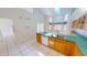 Bright kitchen with white appliances, tile flooring, and abundant natural light from skylight at 2244 Mauritania Rd, Punta Gorda, FL 33983