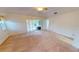 Carpeted main bedroom with fan, ensuite bathroom, and access to sunroom at 2244 Mauritania Rd, Punta Gorda, FL 33983