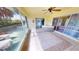 Relaxing tiled sunroom featuring a hot tub and lush landscaping, and access to backyard at 2244 Mauritania Rd, Punta Gorda, FL 33983