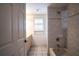 Bright bathroom featuring a bathtub with tile surround and a window at 23101 Hillsdale Ave, Port Charlotte, FL 33954