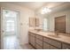 Bathroom with dual sinks, vanity, and tiled floors at 23101 Hillsdale Ave, Port Charlotte, FL 33954