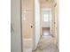 Hallway leading to a bathroom and bedroom with beautiful tile flooring at 23101 Hillsdale Ave, Port Charlotte, FL 33954