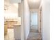 Hallway leads to kitchen and bedrooms with tiled floors at 23101 Hillsdale Ave, Port Charlotte, FL 33954