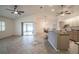 Open living room with high ceilings, tile floors, ceiling fans, and an eat-in kitchen bar at 23101 Hillsdale Ave, Port Charlotte, FL 33954