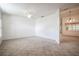 The spacious living room features tile flooring, a ceiling fan, and ample natural light at 23101 Hillsdale Ave, Port Charlotte, FL 33954