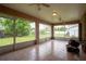 Bright sunroom features tile flooring and large windows overlooking the serene backyard at 23101 Hillsdale Ave, Port Charlotte, FL 33954