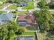 Aerial view of the property featuring the screened-in pool, fenced in yard, and lush surrounding landscape at 2373 Chartwell Ave, North Port, FL 34288