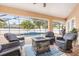 Screened in patio featuring a fire pit and in ground pool at 2373 Chartwell Ave, North Port, FL 34288