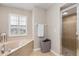 Bright bathroom with soaking tub and glass enclosed shower at 2373 Chartwell Ave, North Port, FL 34288