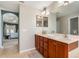 En suite bathroom featuring double sink vanity and access to main bedroom at 2373 Chartwell Ave, North Port, FL 34288