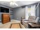 Bedroom featuring accent wall, recliner, and ample light at 2373 Chartwell Ave, North Port, FL 34288