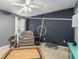 Bedroom featuring accent wall, recliner, and ample light at 2373 Chartwell Ave, North Port, FL 34288