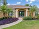 Inviting single-story home featuring double front doors, lush landscaping, and a brick walkway to the entrance at 2373 Chartwell Ave, North Port, FL 34288