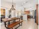 Open concept kitchen and dining area featuring long wooden table and stainless appliances at 2373 Chartwell Ave, North Port, FL 34288