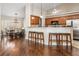 Bright kitchen area connected to a dining space with barstool seating and stainless appliances at 2373 Chartwell Ave, North Port, FL 34288