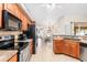 Spacious kitchen featuring stainless steel appliances, tiled floors, and granite countertops at 2373 Chartwell Ave, North Port, FL 34288