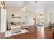 Bright and spacious living room featuring wood floors, a comfortable sofa, and an inviting atmosphere at 2373 Chartwell Ave, North Port, FL 34288