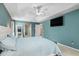 Comfortable main bedroom includes tray ceiling, teal walls and archway to walk-in closet at 2373 Chartwell Ave, North Port, FL 34288