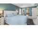 Spacious main bedroom features blue accent wall, walk-in closet and neutral carpet at 2373 Chartwell Ave, North Port, FL 34288