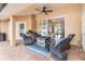 Charming covered patio with a brick floor, ceiling fan, and comfortable seating, perfect for relaxation at 2373 Chartwell Ave, North Port, FL 34288