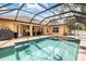 Relaxing screened-in pool area with a refreshing pool, and outdoor seating, ideal for entertaining at 2373 Chartwell Ave, North Port, FL 34288