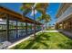 Picturesque backyard with boat dock, lush lawn, and manicured landscaping, offering a serene waterfront retreat at 24261 Captain Kidd Blvd, Punta Gorda, FL 33955