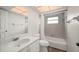 Cozy bathroom featuring a tub with tiled walls, a modern vanity, and updated fixtures at 24261 Captain Kidd Blvd, Punta Gorda, FL 33955