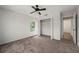 Carpeted bedroom with closet, ceiling fan and ample light from the window at 24261 Captain Kidd Blvd, Punta Gorda, FL 33955
