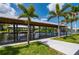 Scenic view of a private boat dock with a covered lift, surrounded by lush tropical landscaping and serene waters at 24261 Captain Kidd Blvd, Punta Gorda, FL 33955