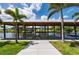Private boat dock featuring covered lift and sunny waterfront views, surrounded by tropical palm trees and serene water at 24261 Captain Kidd Blvd, Punta Gorda, FL 33955