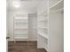 Spacious walk-in closet with custom shelving and ample storage for all your clothing and accessories at 24261 Captain Kidd Blvd, Punta Gorda, FL 33955
