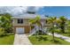 Beautiful waterfront home with two car garage and stairs to the main living level at 24261 Captain Kidd Blvd, Punta Gorda, FL 33955