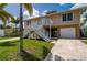 Beautiful waterfront home with two car garage and stairs to the main living level at 24261 Captain Kidd Blvd, Punta Gorda, FL 33955