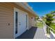 Front door with sidelights and small porch on this waterfront home with access by stairs at 24261 Captain Kidd Blvd, Punta Gorda, FL 33955