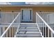 Front door of the home with stairs and small porch with nice curb appeal at 24261 Captain Kidd Blvd, Punta Gorda, FL 33955