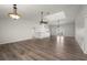 Open concept living area features wood-look floors, vaulted ceilings, and a skylight for natural light at 24261 Captain Kidd Blvd, Punta Gorda, FL 33955