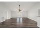 Bright and airy living room with laminate floors, ceiling fan, and convenient access to the main entrance at 24261 Captain Kidd Blvd, Punta Gorda, FL 33955