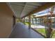 Covered patio leads to waterfront with boat dock and lush landscaping at 24261 Captain Kidd Blvd, Punta Gorda, FL 33955