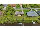 Scenic aerial perspective reveals the proximity to canals, neighboring houses, lawns, and overall neighborhood layout and design at 2467 Herron Ter, Port Charlotte, FL 33981