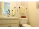 Bathroom featuring a sink, vanity, mirror, and toilet at 2467 Herron Ter, Port Charlotte, FL 33981