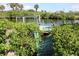 Damaged waterfront boat dock with mangroves, hinting at potential for canal-front property with repair opportunities at 2467 Herron Ter, Port Charlotte, FL 33981