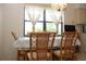 Cozy dining area with a large window providing ample light and woven-back chairs at 2467 Herron Ter, Port Charlotte, FL 33981