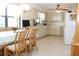 Bright kitchen with tiled floor, white cabinets, and a dining area with woven-back chairs at 2467 Herron Ter, Port Charlotte, FL 33981