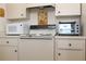 Kitchen area showing white appliances and cabinets with hardware at 2467 Herron Ter, Port Charlotte, FL 33981