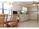 Bright eat-in kitchen with tile floor, white cabinets and large window at 2467 Herron Ter, Port Charlotte, FL 33981
