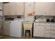 Functional laundry room with washer, dryer, wash basin, and storage cabinets at 2467 Herron Ter, Port Charlotte, FL 33981