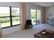 Open living room featuring sliding doors to the outside and a large window for natural light at 2467 Herron Ter, Port Charlotte, FL 33981