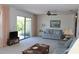 Spacious living room featuring neutral carpeting, sliding doors to the outside, and comfortable seating at 2467 Herron Ter, Port Charlotte, FL 33981