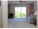 Bright living room with sliding glass doors leading to outdoor scenery and neutral carpet at 2467 Herron Ter, Port Charlotte, FL 33981